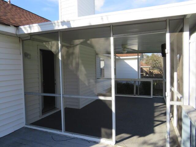 view of patio featuring a sunroom