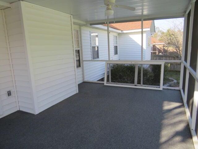 unfurnished sunroom featuring ceiling fan