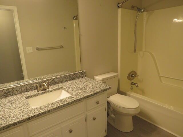 full bath featuring shower / tub combination, vanity, and toilet