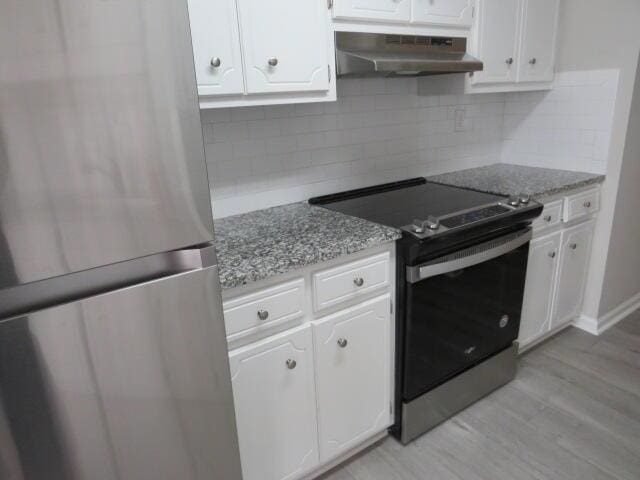 kitchen with stainless steel appliances, white cabinetry, and under cabinet range hood