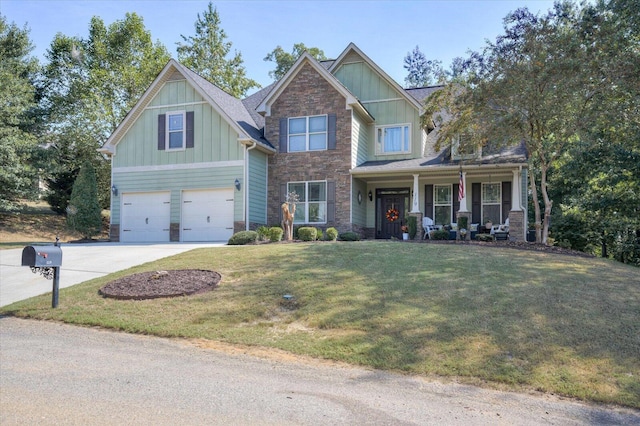 craftsman inspired home featuring covered porch, a garage, and a front lawn