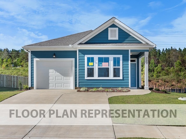 view of front of home with a garage and a front yard