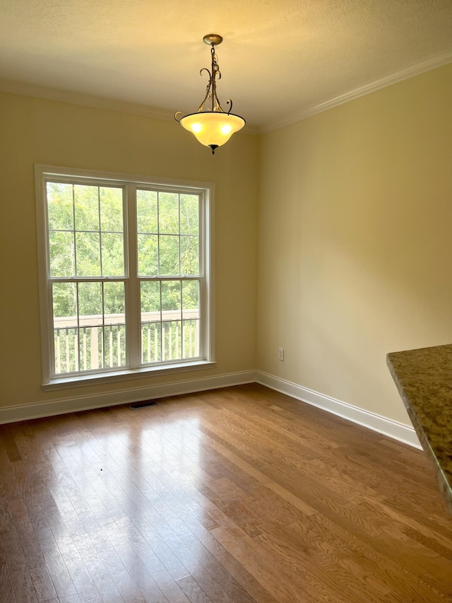 1124 Brighton Dr, Evans, GA 30809 - unfurnished dining area featuring dark wood finished floors, ornamental molding, and a textured ceiling