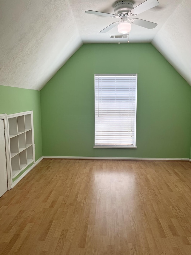 1124 Brighton Dr, Evans, GA 30809 - bonus room with wood finished floors, lofted ceiling, ceiling fan, and a textured ceiling