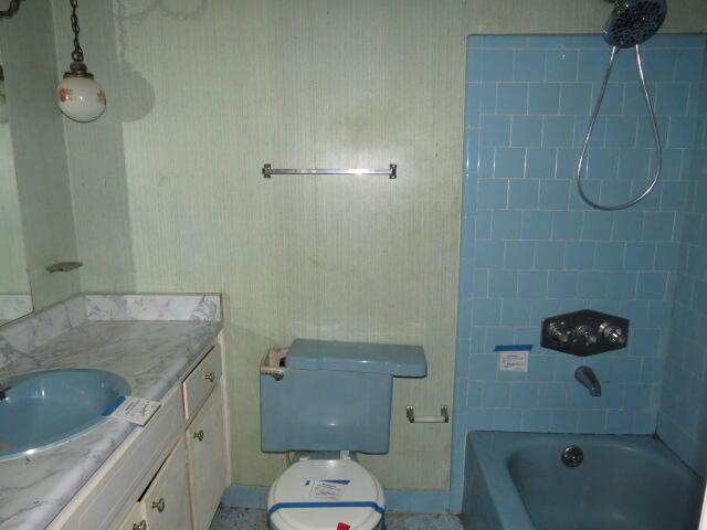 full bath with toilet, shower / washtub combination, and vanity