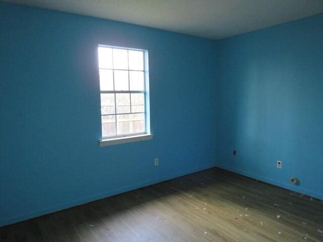 unfurnished room with wood finished floors