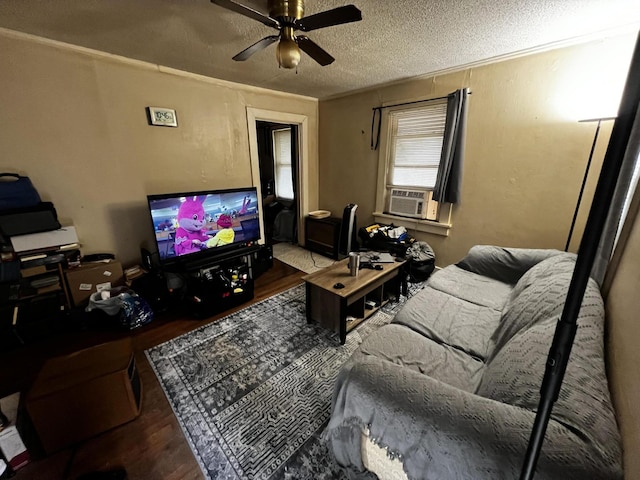 living room with ceiling fan, hardwood / wood-style floors, cooling unit, and a textured ceiling