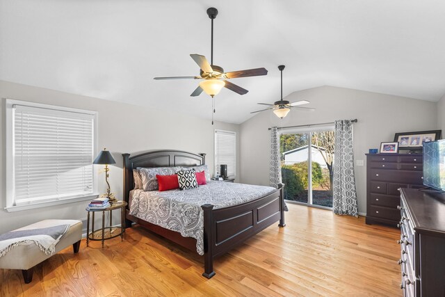 bedroom featuring access to exterior, vaulted ceiling, light wood-style flooring, and a ceiling fan