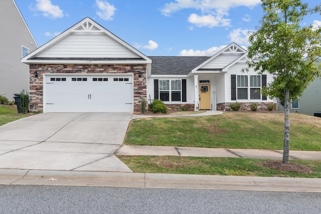 craftsman-style home featuring a front yard and a garage