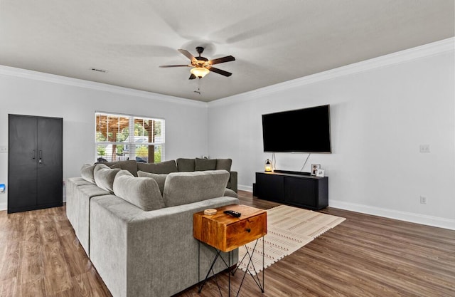 living room with ceiling fan, dark hardwood / wood-style flooring, and crown molding