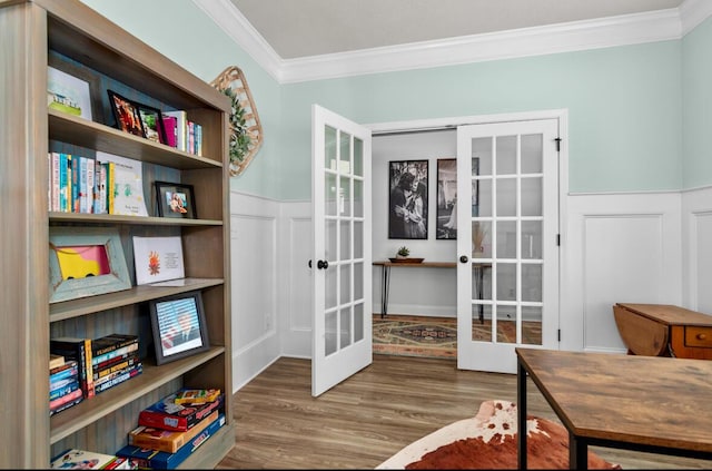 office with wood-type flooring, ornamental molding, and french doors