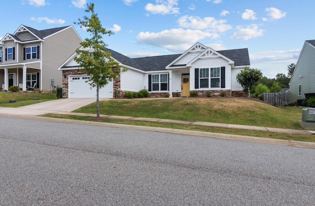 craftsman inspired home with a garage and a front yard