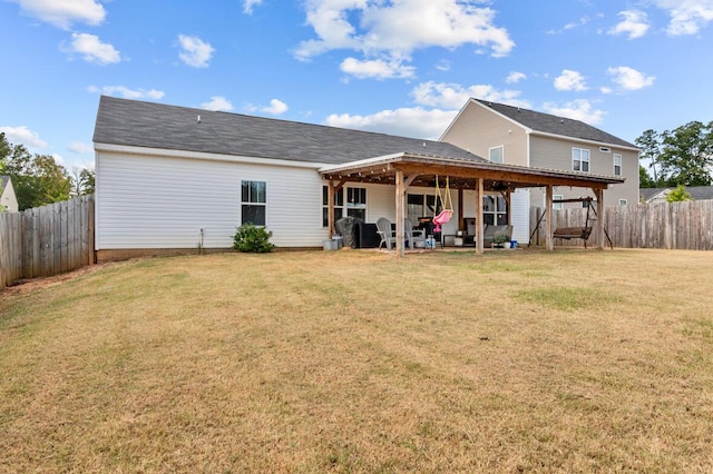 rear view of house with a patio area and a yard