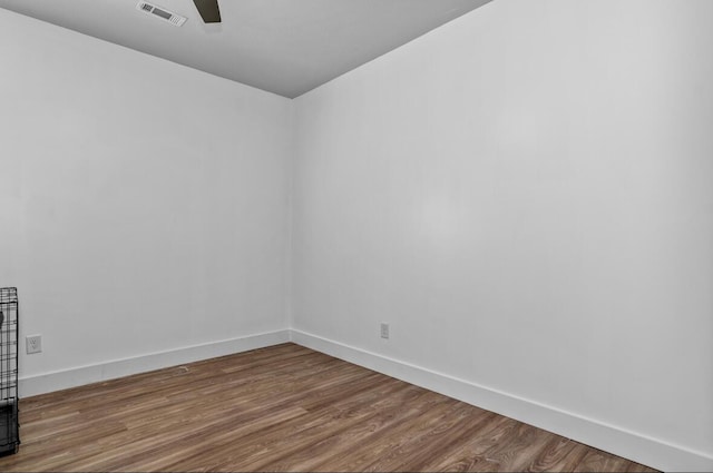 empty room featuring ceiling fan and hardwood / wood-style floors