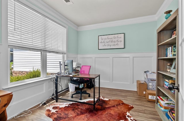 office with wood-type flooring and crown molding