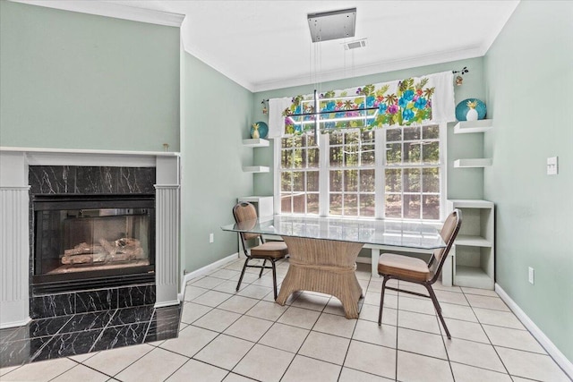 tiled dining space featuring a high end fireplace and crown molding