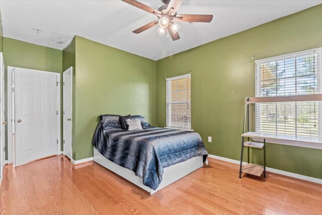 bedroom with hardwood / wood-style floors and ceiling fan