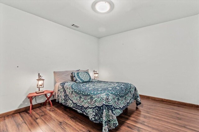 bedroom featuring dark wood-type flooring