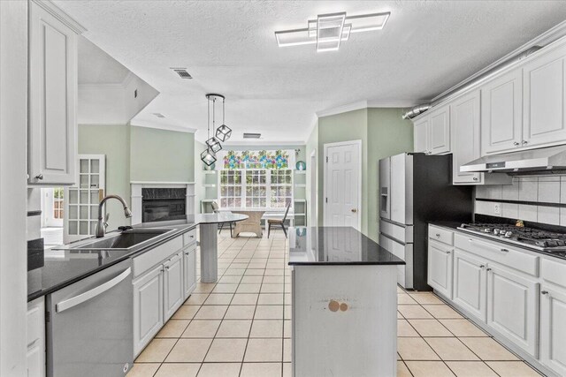 kitchen with white cabinets, appliances with stainless steel finishes, and a center island