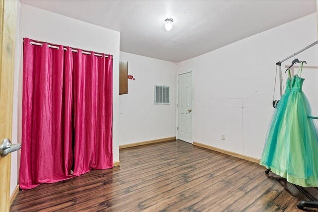 empty room with dark hardwood / wood-style flooring