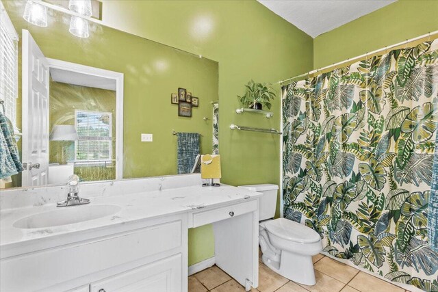 bathroom featuring tile patterned floors, vanity, and toilet