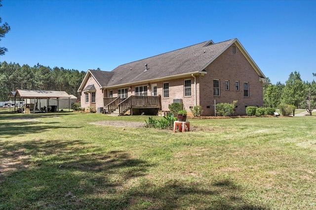 rear view of property featuring a carport, a yard, and a wooden deck