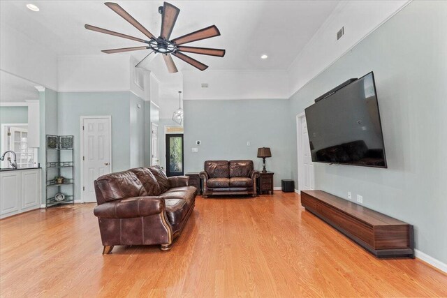 living room with light wood-type flooring and ceiling fan