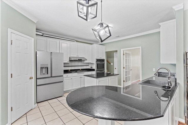 kitchen with white cabinets, appliances with stainless steel finishes, hanging light fixtures, and crown molding