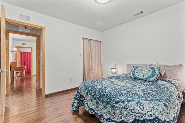 bedroom with hardwood / wood-style flooring