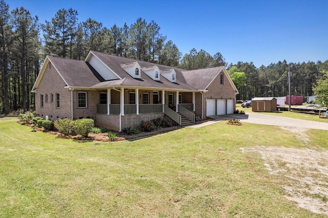 view of front of home with a front lawn, covered porch, and an outdoor structure