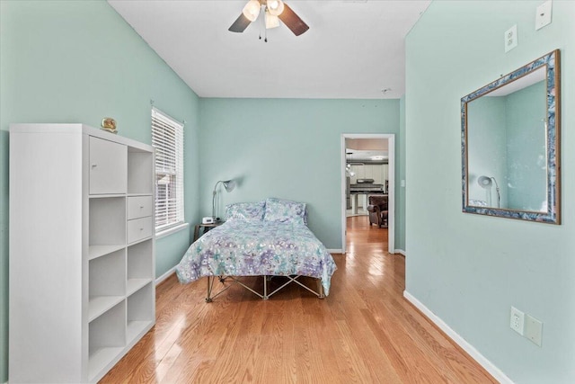 bedroom with ceiling fan and light hardwood / wood-style floors