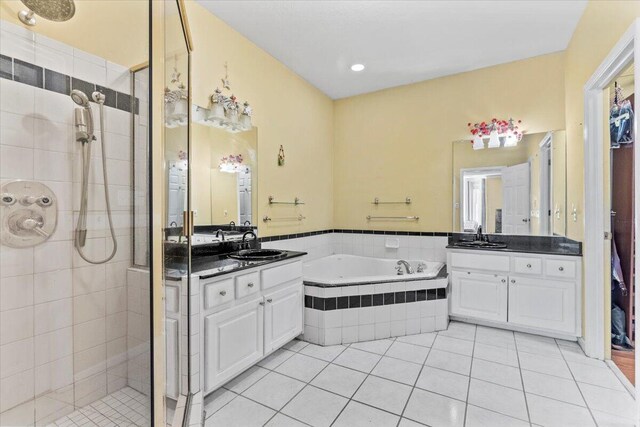 bathroom with plus walk in shower, vanity, and tile patterned floors