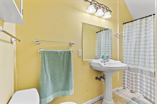 bathroom with tile patterned flooring, toilet, and sink