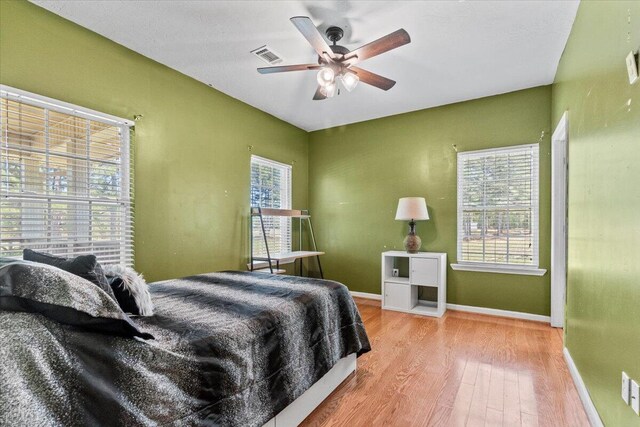 bedroom with hardwood / wood-style floors and ceiling fan