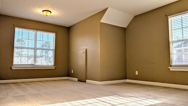 unfurnished room with baseboards and light colored carpet