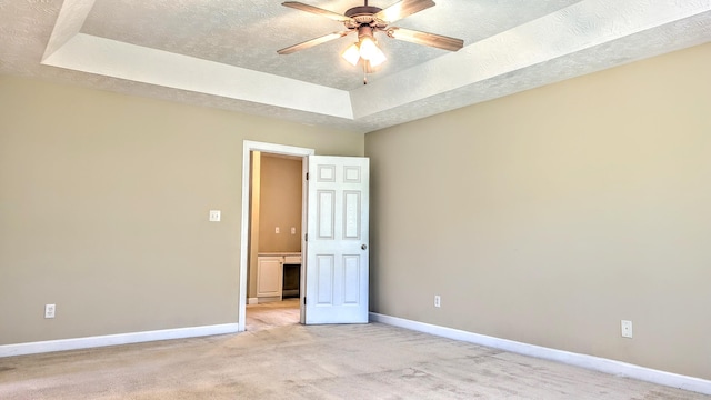 627 Surrey Ln, Martinez, GA 30907 - spare room featuring light carpet, baseboards, a textured ceiling, and a raised ceiling