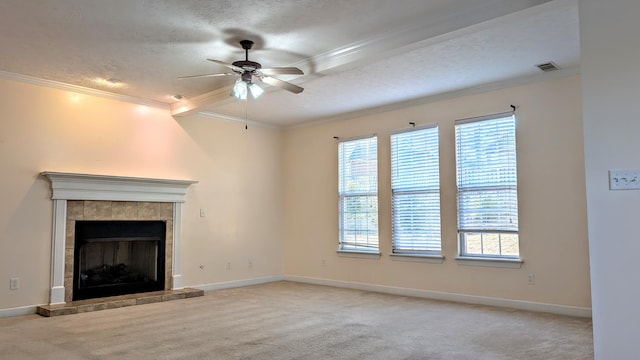 unfurnished living room featuring carpet floors, plenty of natural light, crown molding, and a tiled fireplace