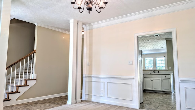 627 Surrey Ln, Martinez, GA 30907 - interior space with a sink, a chandelier, a textured ceiling, crown molding, and stairway