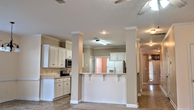 kitchen featuring ornamental molding, white refrigerator with ice dispenser, stainless steel microwave, and visible vents