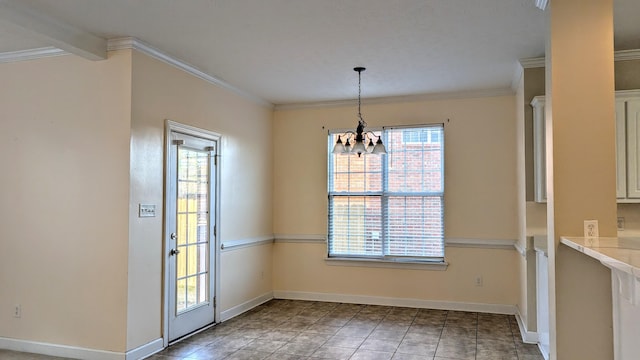 unfurnished dining area with a chandelier, ornamental molding, and baseboards