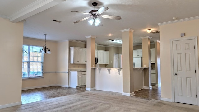 kitchen with light tile patterned floors, light colored carpet, a ceiling fan, white cabinets, and fridge