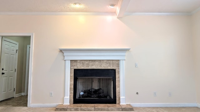 interior details featuring ornamental molding, carpet flooring, a tile fireplace, and baseboards