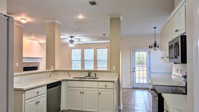 kitchen featuring a sink, visible vents, white cabinets, appliances with stainless steel finishes, and crown molding