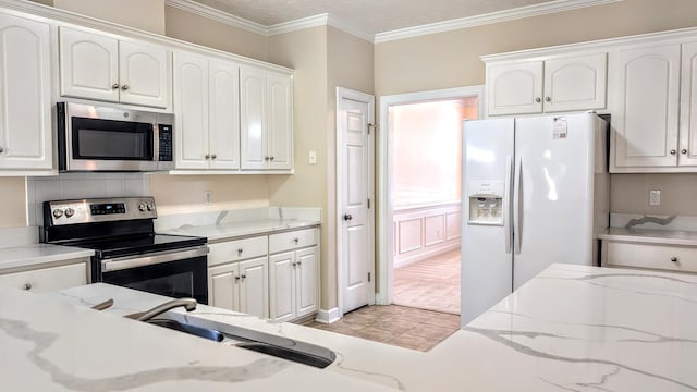 627 Surrey Ln, Martinez, GA 30907 - kitchen with ornamental molding, light tile patterned floors, white cabinets, light stone countertops, and stainless steel appliances