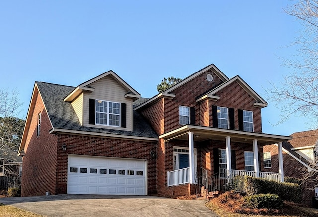 traditional-style house with covered porch, brick siding, driveway, and roof with shingles