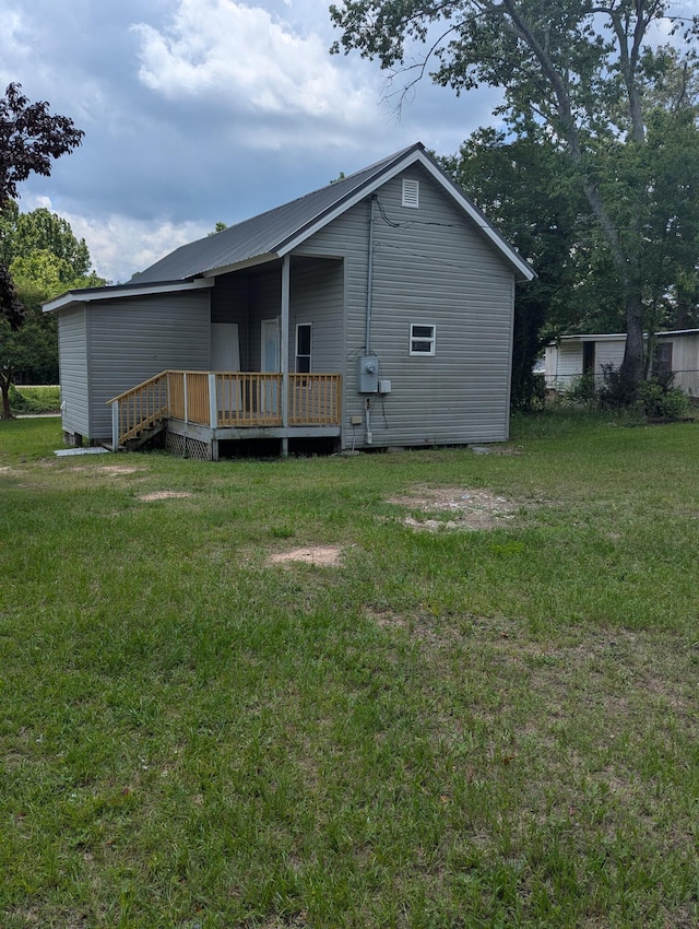 166 Front St, Warrenville, SC 29851 - rear view of house with a deck, a yard, and metal roof