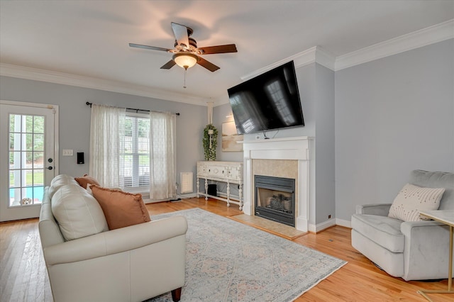 210 Oleander Trl, Evans, GA 30809 - living room with a fireplace with flush hearth, healthy amount of natural light, crown molding, ceiling fan, and light wood-style floors
