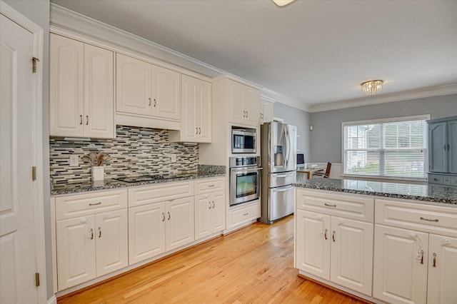 210 Oleander Trl, Evans, GA 30809 - kitchen with stainless steel appliances, ornamental molding, decorative backsplash, dark stone counters, and light wood finished floors