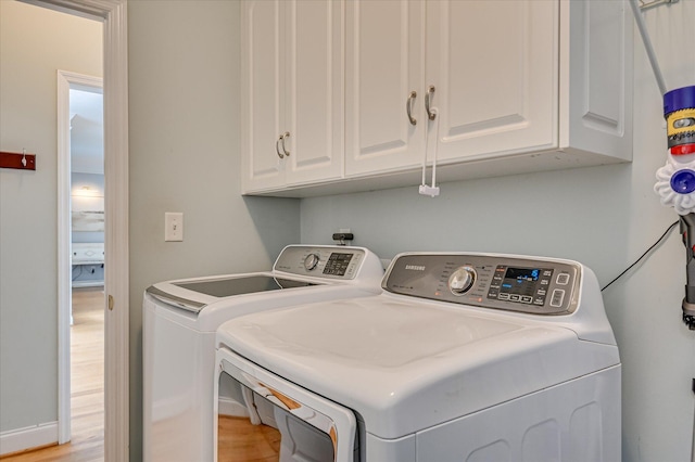 210 Oleander Trl, Evans, GA 30809 - laundry room with independent washer and dryer, cabinet space, and light wood-type flooring