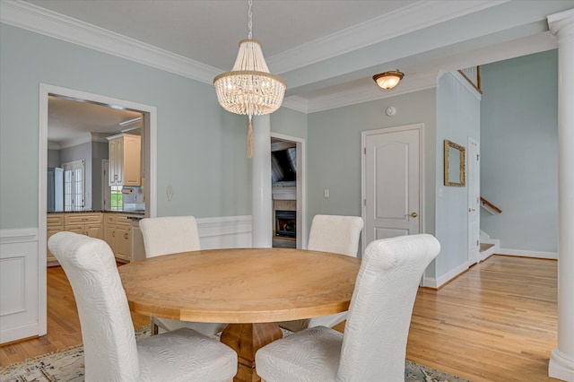 210 Oleander Trl, Evans, GA 30809 - dining room with stairs, ornamental molding, light wood-type flooring, a chandelier, and wainscoting